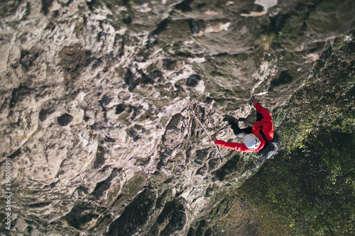 Fully equipped climber climbs on the rock 