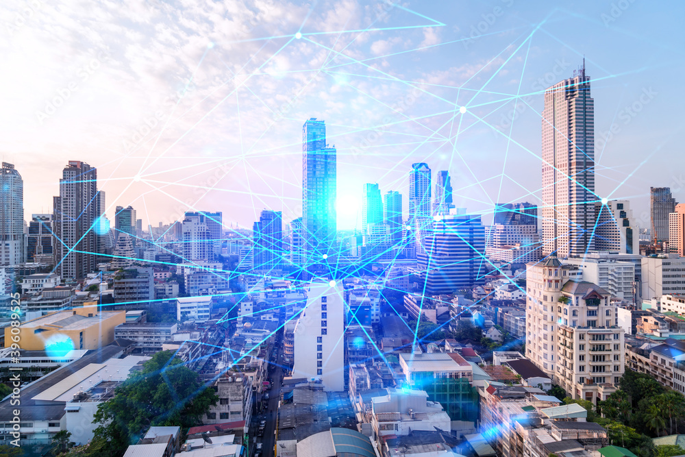 Obraz premium Hologram of abstract technology glowing icons, panoramic cityscape of Bangkok at sunset, Asia. The concept of worlds technological changes. Double exposure.