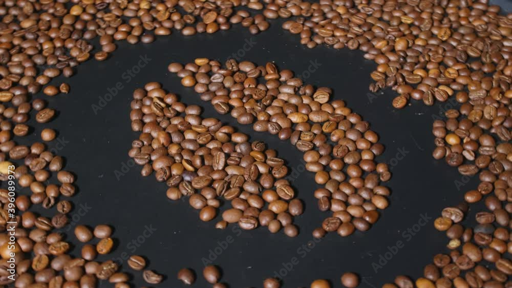 Rotating dark board with roasted coffee beans Rotating dark board with roasted coffee beans