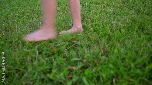 children's legs gently pass on the green grass