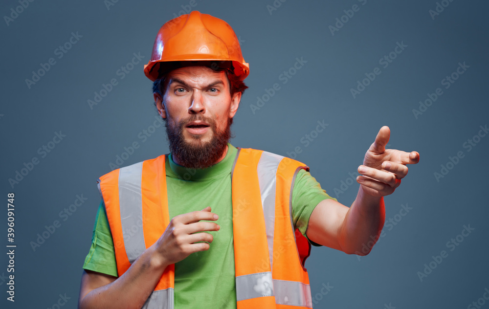 Male worker in orange paint emotions construction studio Male worker in orange paint emotions construction studio