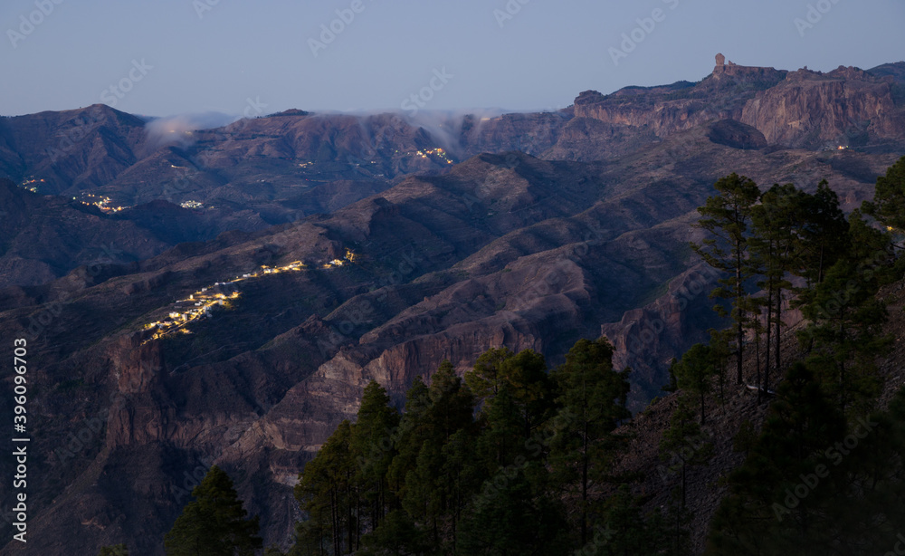 Roque Nublo to the right and village of El Toscon in the foreground at sunset. The Nublo Rural Park. Gran Canaria. Canary Islands. Spain.