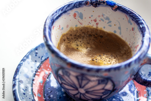 a cosy winterly snowflake cup of strong espresso