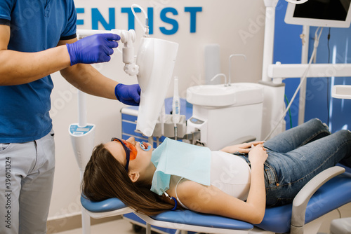 A patient in the dentist with ultraviolet lamp on her teeth