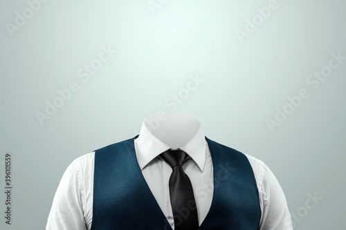Businessman in a white shirt, vest and headless tie on a light background. Copy space.