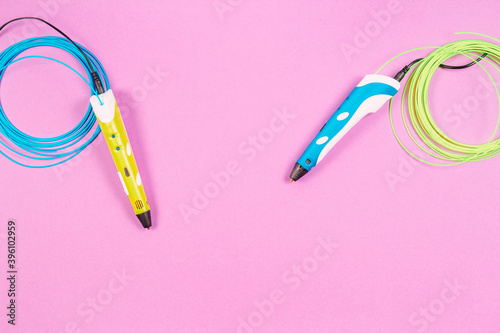 3d pens with colourful plastic filament on pink background © vejaa
