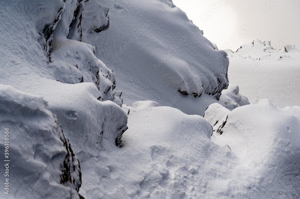 Isolated rock covered by snow in winter. Glaciers 3000, Diablerets in Switzerland. Isolated rock covered by snow in winter. Glaciers 3000, Diablerets in Switzerland.