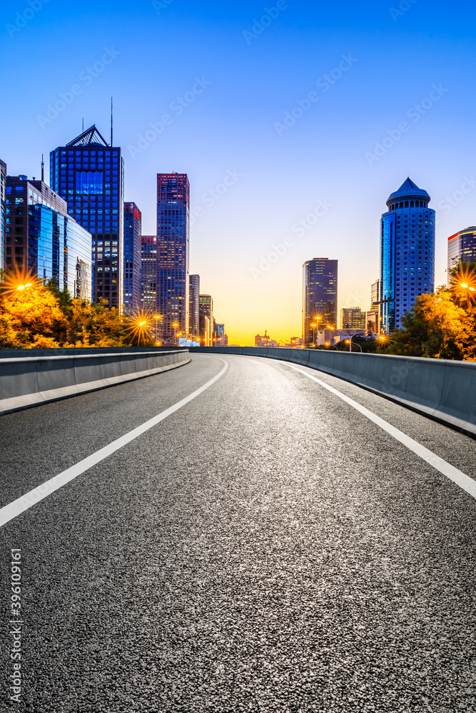 Empty asphalt road and modern cityscape in Beijing at sunset,China.