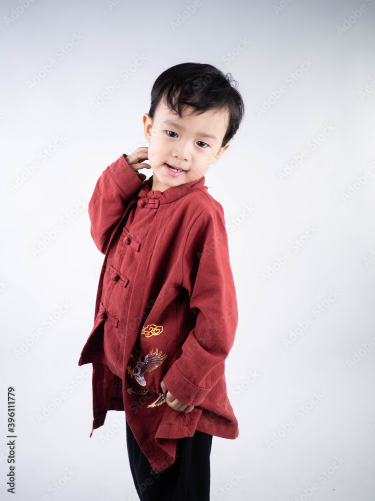Happy Chinese new year. Asian boy in cheongsam of traditional chinese dress on white background. Happy Chinese new year. Asian boy in cheongsam of traditional chinese dress on white background.