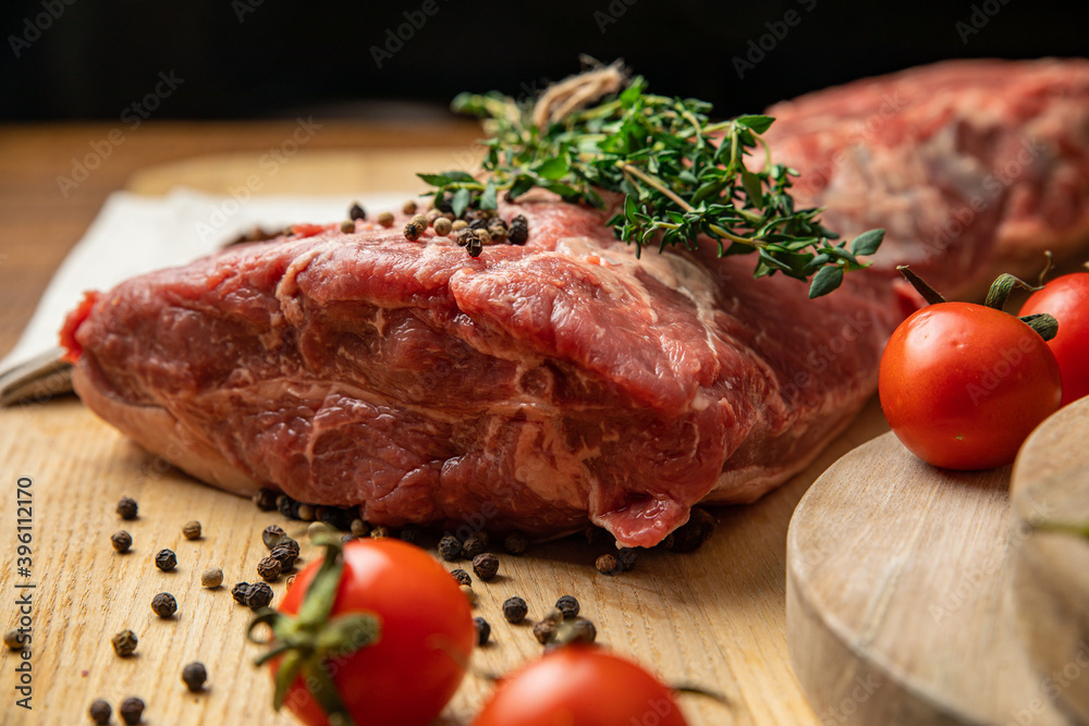 Raw Meat Sliced Pieces Of Beef With Spices And Herbs On A Wooden Board 