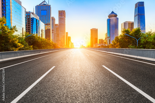 Empty asphalt road and modern cityscape in Beijing at sunset,China.