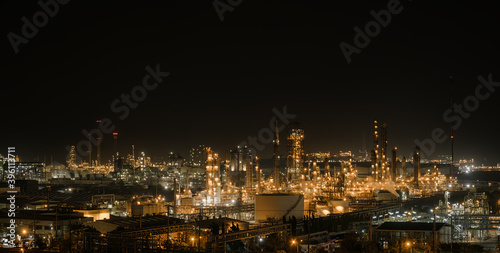 Panorama of Oil and Gas refinery industry plant with glitter lighting, Factory of petroleum industrial at night time, Petrochemical plant with gas distillation tower and storage tank
