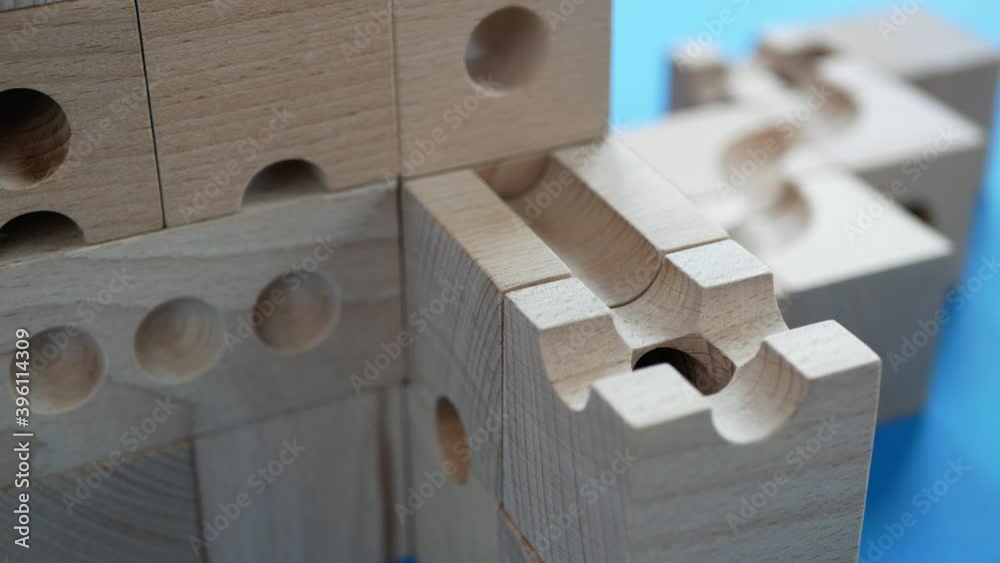 Wooden construction with path in which colored balls is moving, Marble runs, Concept of engineering, designing and construction