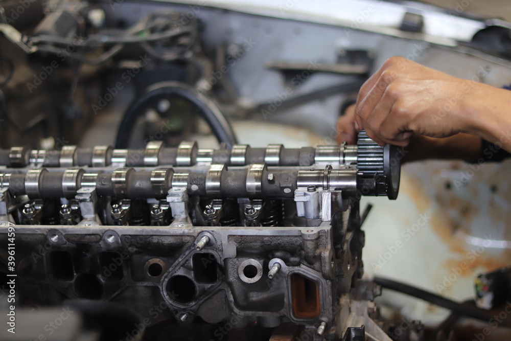 The mechanic is checking the engine. The mechanic is checking the engine.