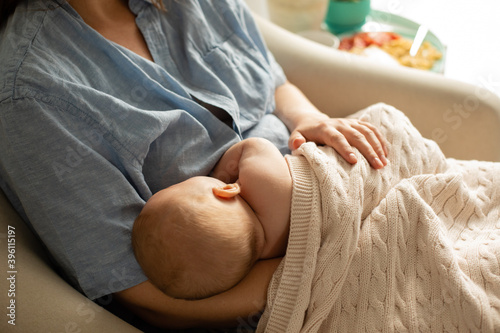 Mom and newborn baby resting after breastfeeding photo