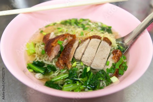 Egg noodle with roast duck in clear soup. 