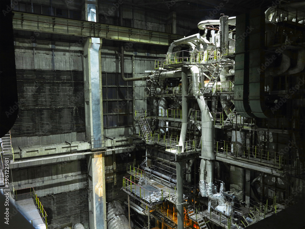 Pipes, steel tubes, steam turbine and equipment at power plant, night scene