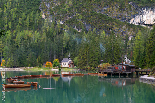 Little chapel at Lake Braies (Pragser Wildsee, Lago di Braies) with boats in foreground. Region of Trentino Alto Adige, Dolomites, Italy