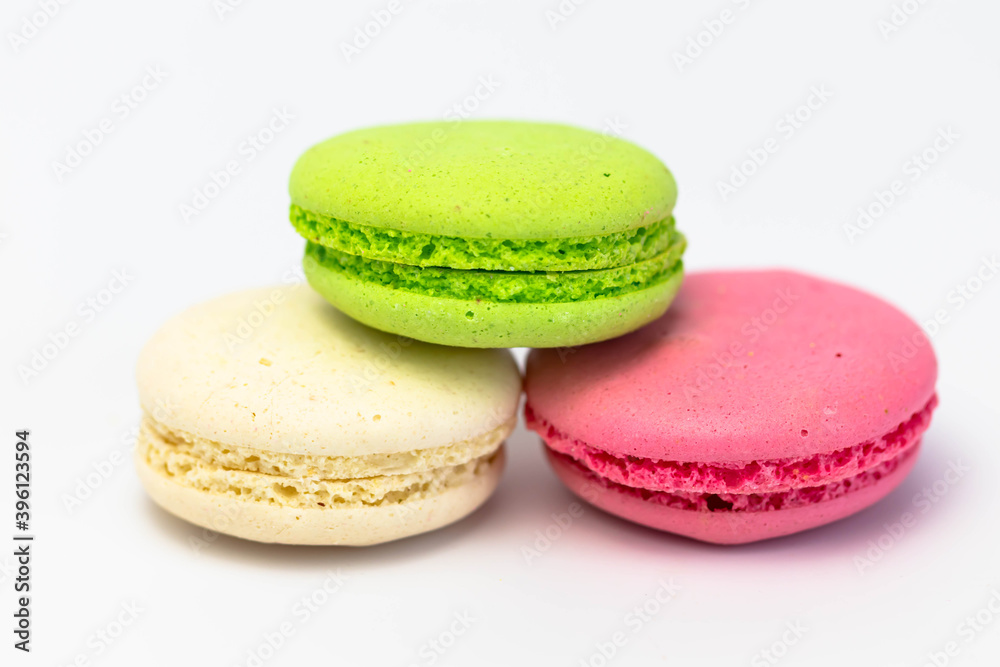 Macaroons isolated on the white background.Homemade french style colorful macaroons. Green, white, pink cookies. Macaroons isolated on the white background.Homemade french style colorful macaroons. Green, white, pink cookies.