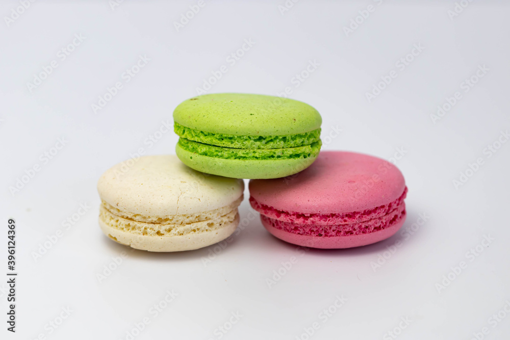Macaroons isolated on the white background.Homemade french style colorful macaroons. Green, white, pink cookies.
