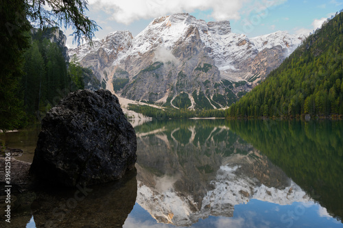 View of Mount Seekofel mirroring in the clear calm water of iconic mountain lake Pragser Wildsee (Lago di Braies) in Italy, Dolomites, Unesco World Heritage, South Tyrol