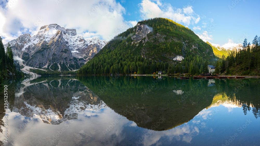 Panoramic view of Mount Seekofel mirroring in the clear calm water of iconic mountain lake Pragser Wildsee (Lago di Braies) in Italy, Dolomites, Unesco World Heritage, South Tyrol