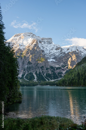 View of Mount Seekofel mirroring in the clear calm water of iconic mountain lake Pragser Wildsee (Lago di Braies) in Italy, Dolomites, Unesco World Heritage, South Tyrol
