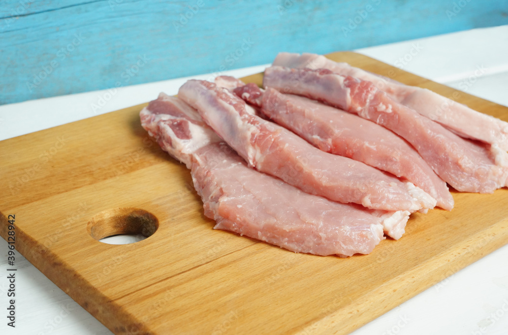 chopped pieces of pork loin on a cutting board, fatty meat chopped pieces of pork loin on a cutting board, fatty meat