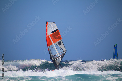 Windsurfer riding ocean waves (Atlantic ocean in El Medano, Tenerife, Spain) photo