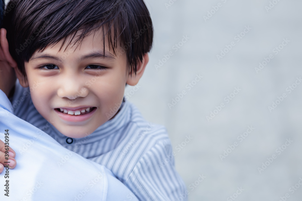 Happy family concept Handsome young boy embracing father. Portrait smiling little son hugging father with happiness and smile face. Child get happy when meet Dad. Health care and insurance, copy space Happy family concept Handsome young boy embracing father. Portrait smiling little son hugging father with happiness and smile face. Child get happy when meet Dad. Health care and insurance, copy space