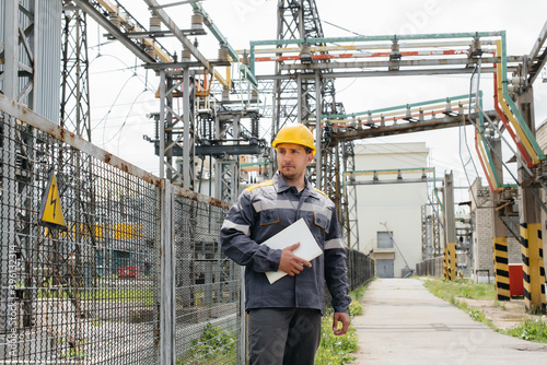 The energy engineer inspects the equipment of the substation. Power engineering. Industry