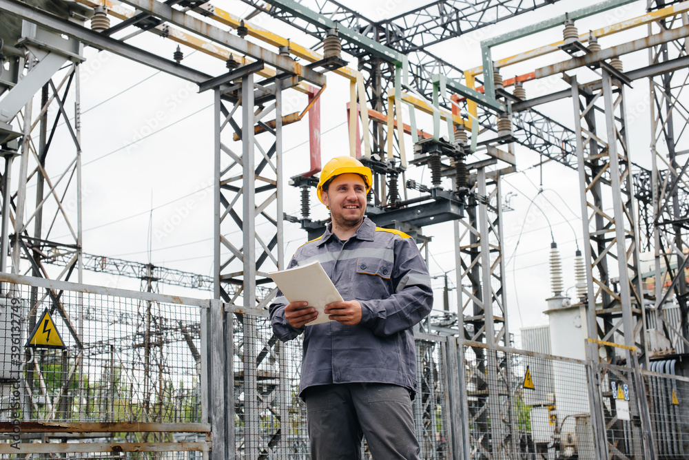 The energy engineer inspects the equipment of the substation. Power engineering. Industry