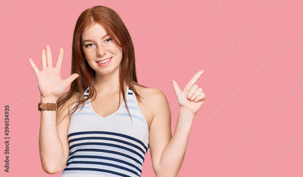 Young read head woman wearing casual clothes showing and pointing up with fingers number seven while smiling confident and happy. Young read head woman wearing casual clothes showing and pointing up with fingers number seven while smiling confident and happy.