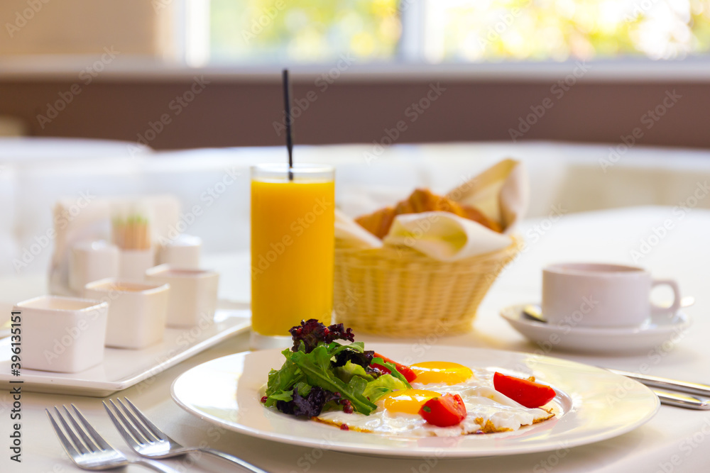 Tasty breakfast with scrambled eggs, juice, croissant and cup of coffe Tasty breakfast with scrambled eggs, juice, croissant and cup of coffe
