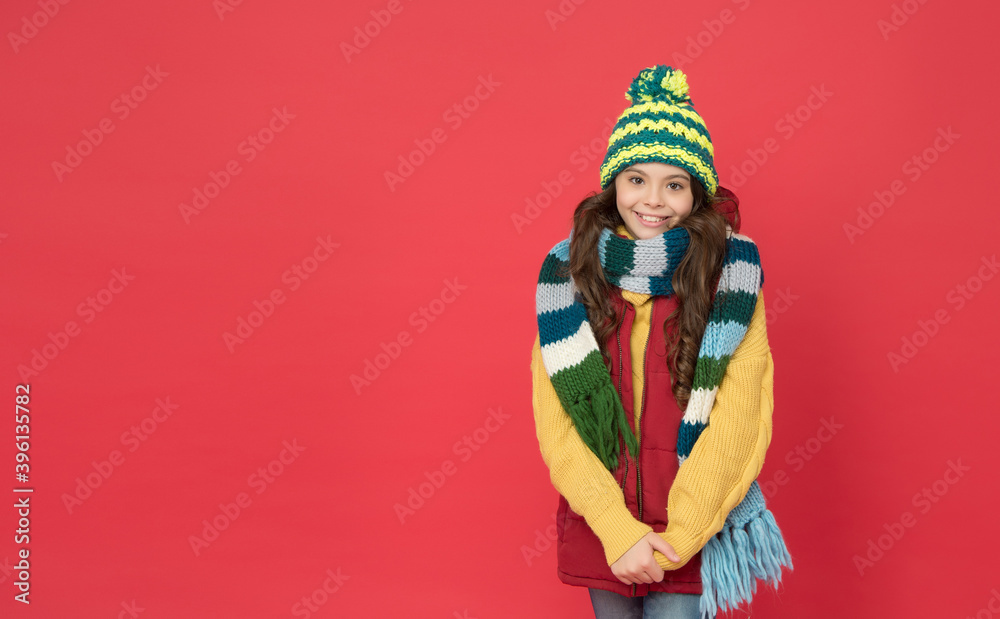 happy teen girl in knitted scarf and hat wear warm clothes in winter season, copy space, casual style