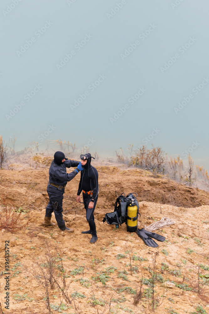Lifeguard in a wetsuit to work underwater. Search at the bottom of the pond. Lifeguard in a wetsuit to work underwater. Search at the bottom of the pond.
