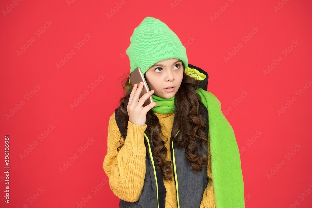 extremely happy kid girl with long hair wear warm clothes and speak on modern mobile phone, communication extremely happy kid girl with long hair wear warm clothes and speak on modern mobile phone, communication