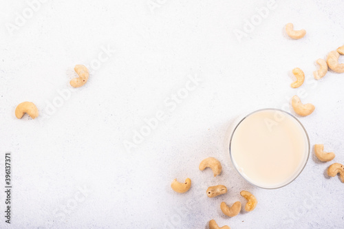 Vegan Cashew nut milk on white background. Non dairy alternative vegan milk. Healthy vegetarian food and drink. Copy space  top view