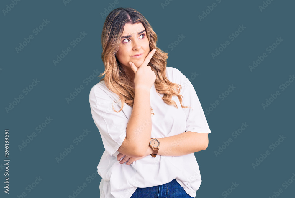 Young caucasian woman wearing casual clothes thinking worried about a question, concerned and nervous with hand on chin Young caucasian woman wearing casual clothes thinking worried about a question, concerned and nervous with hand on chin