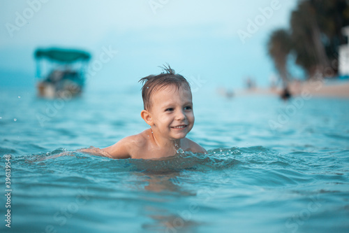 Boy laughs swims in the sea