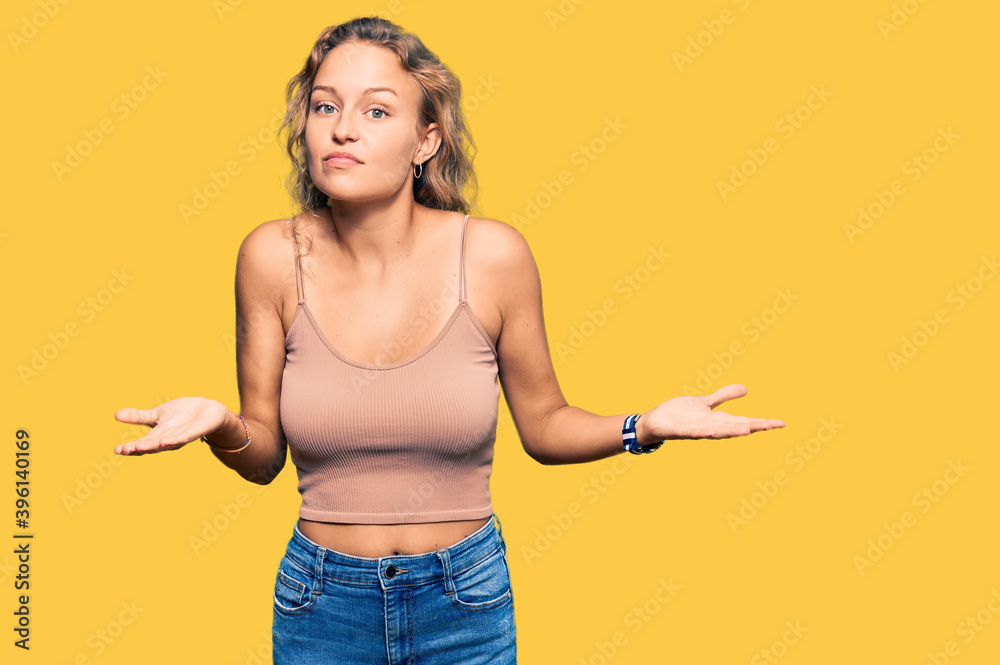 Beautiful caucasian woman wearing casual clothes clueless and confused expression with arms and hands raised. doubt concept. Beautiful caucasian woman wearing casual clothes clueless and confused expression with arms and hands raised. doubt concept.