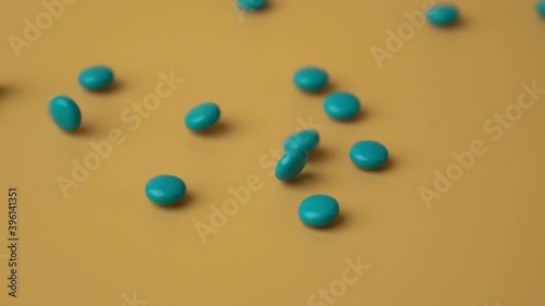 blue pills falling with slow motion