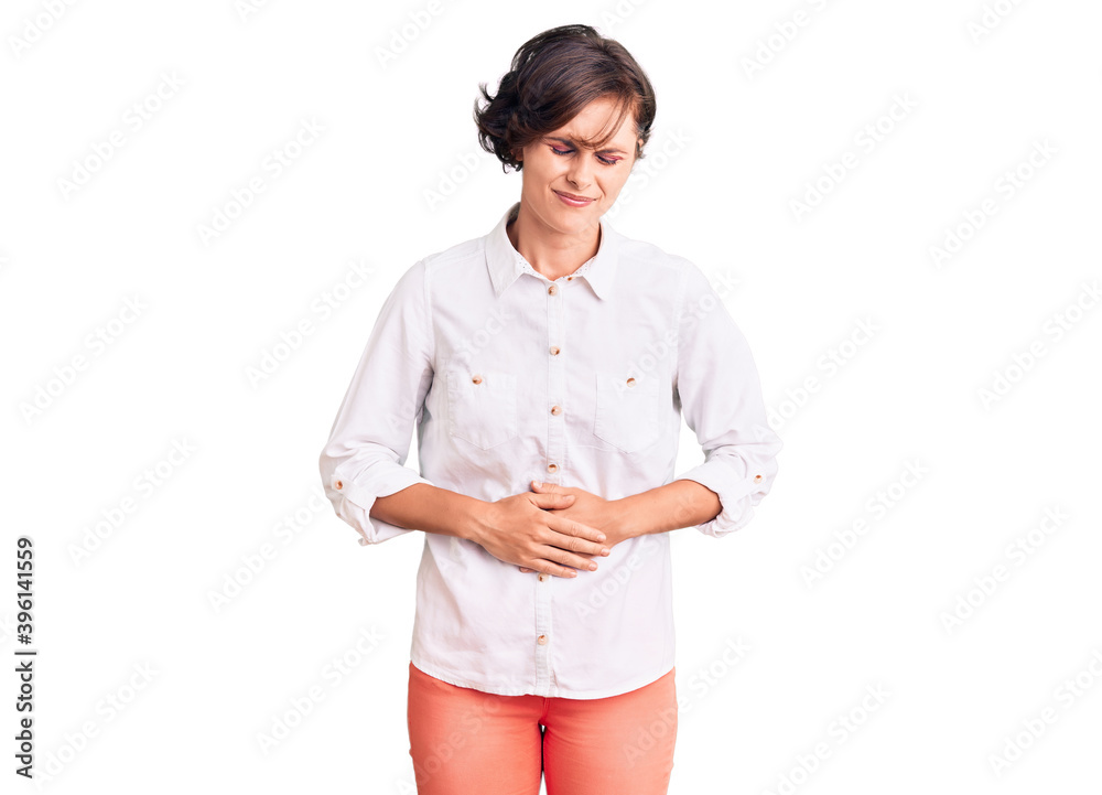Beautiful young woman with short hair wearing elegant white shirt with hand on stomach because indigestion, painful illness feeling unwell. ache concept. Beautiful young woman with short hair wearing elegant white shirt with hand on stomach because indigestion, painful illness feeling unwell. ache concept.