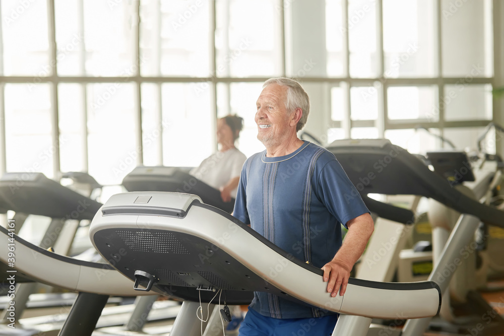 Older caucasian man on treadmill at gym. Senior man training his body at gym. Stay active and healthy. Older caucasian man on treadmill at gym. Senior man training his body at gym. Stay active and healthy.