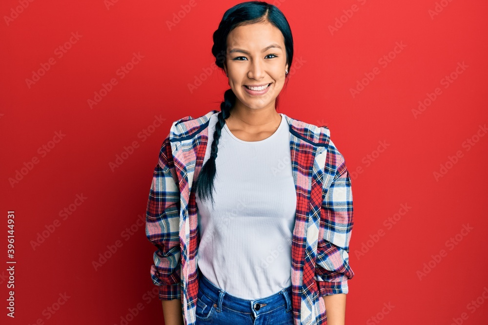 Beautiful hispanic woman wearing casual clothes with a happy and cool smile on face. lucky person. Beautiful hispanic woman wearing casual clothes with a happy and cool smile on face. lucky person.