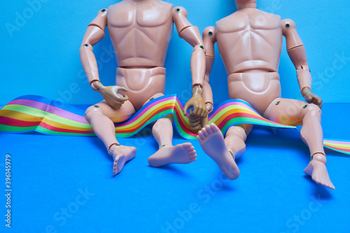 Εκτύπωση καμβά Gay couple of male dolls lying on the bed with the rainbow flag LGTB pride