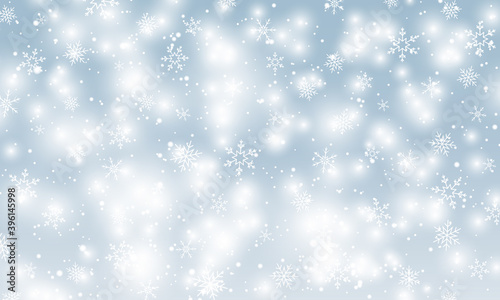 Snow background. Winter snowfall. White snowflakes on blue sky. Christmas background. Falling snow.
