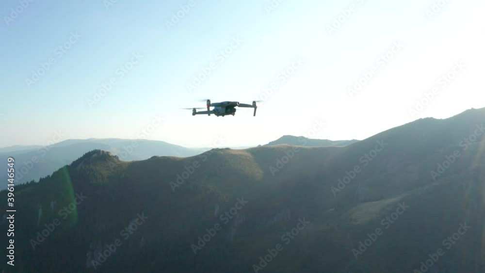 Closeup in air of a drone flying over the mountains Closeup in air of a drone flying over the mountains