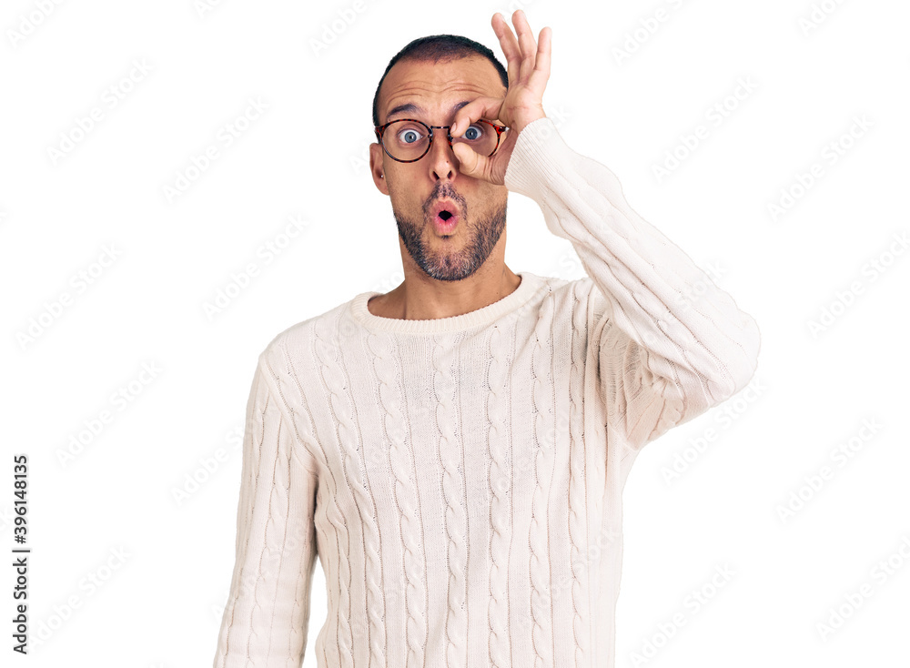 Young handsome man wearing casual clothes and glasses doing ok gesture shocked with surprised face, eye looking through fingers. unbelieving expression. Young handsome man wearing casual clothes and glasses doing ok gesture shocked with surprised face, eye looking through fingers. unbelieving expression.