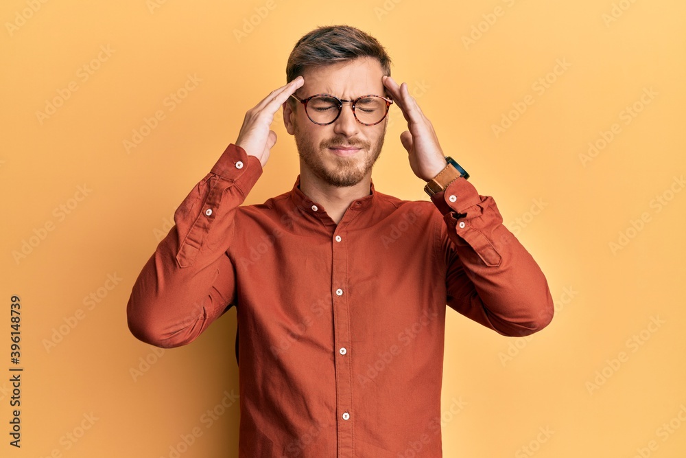 Handsome caucasian man wearing casual clothes and glasses with hand on head, headache because stress. suffering migraine. Handsome caucasian man wearing casual clothes and glasses with hand on head, headache because stress. suffering migraine.